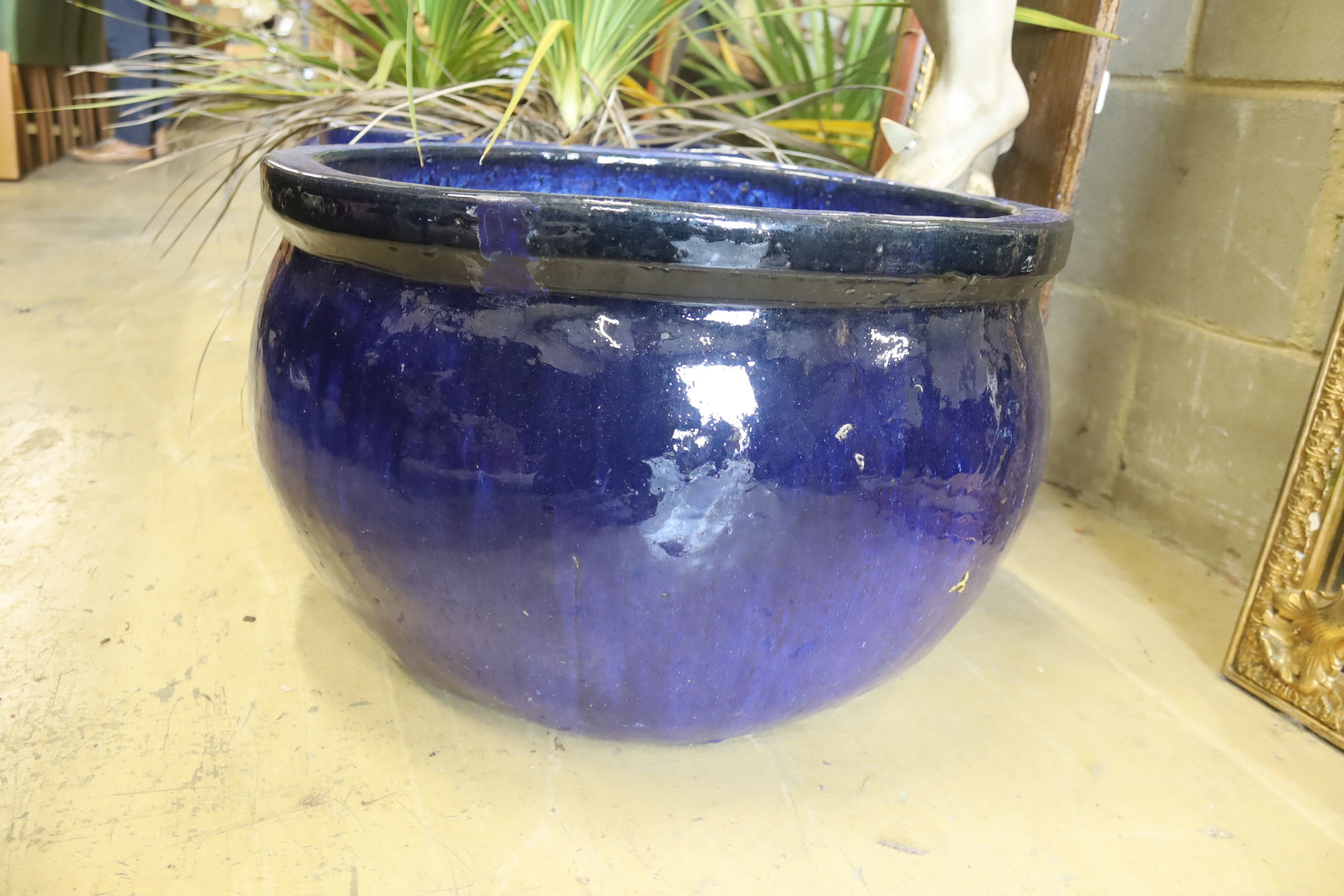 A set of three circular blue glazed garden planters, diameter 52cm, height 34cm